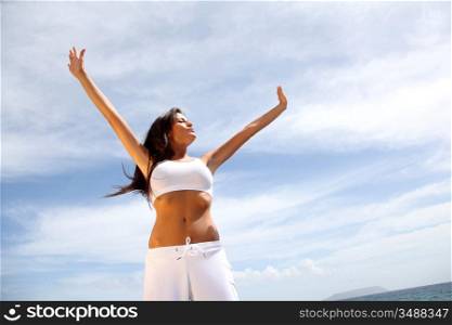 Woman stretching arms towards the sky