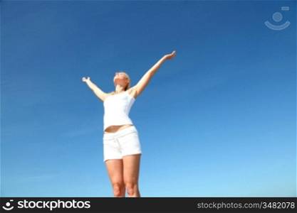 Woman stretching arms up from freedom