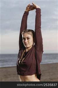 woman stretching by beach 2