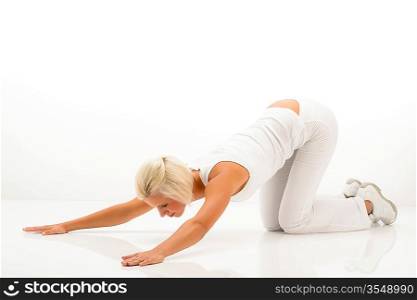 Woman stretching her back fitness yoga exercise on white floor