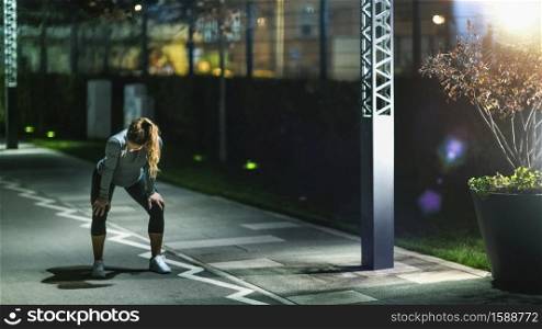 Woman Stretching, Late Night Training in the City. Woman Stretching, Late Night Training