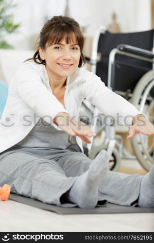 woman stretching legs in fitness center