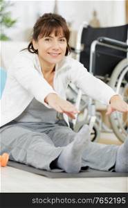woman stretching legs in fitness center