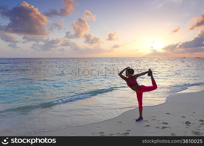 Woman stretching on beach