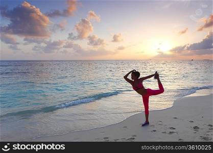 Woman stretching on beach