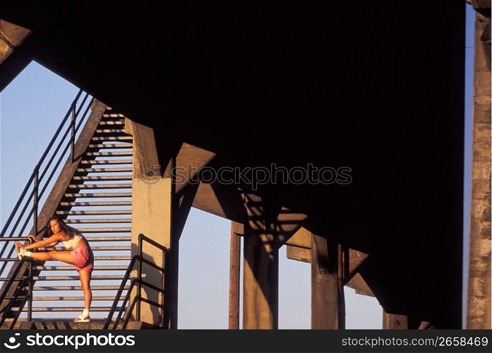 Woman stretching on stairs