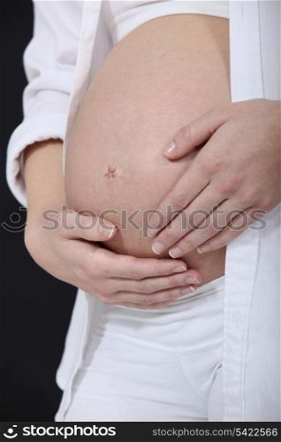 Woman stroking her pregnant belly