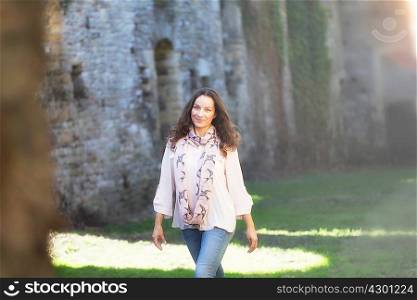 Woman strolling near walls of Thornbury Castle, South Gloucestershire, UK