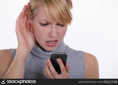 Woman struggling to have a conversation on speaker phone