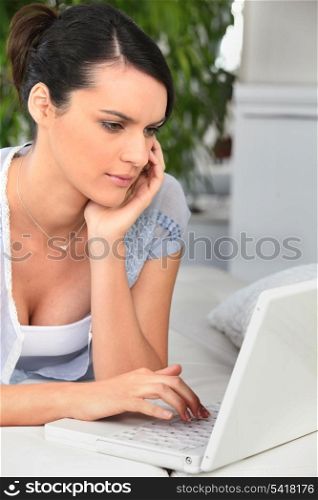 Woman studying at home on the sofa
