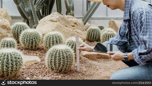 woman studying different plants with tablet 2