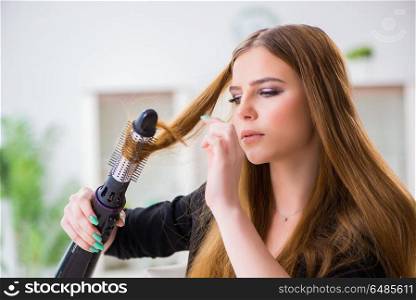 Woman styling her hair with hairdryer