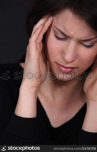 Woman suffering from a throbbing headache