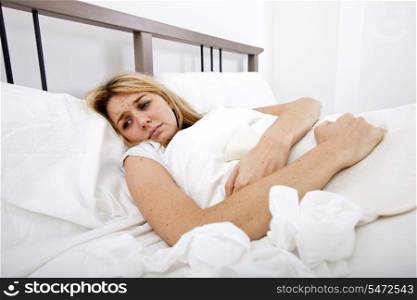 Woman suffering from abdomen pain in bed