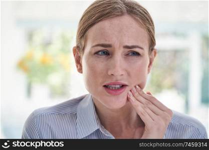 Woman Suffering With Toothache Touching Jaw