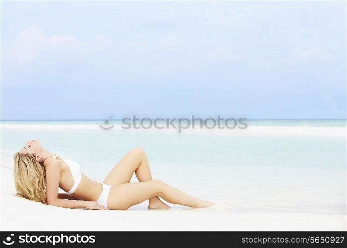 Woman Sunbathing On Beautiful Beach Holiday