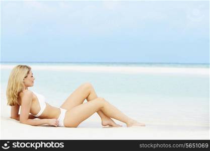 Woman Sunbathing On Beautiful Beach Holiday