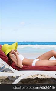Woman sunbathing on tropical beach