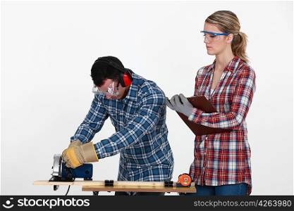 Woman supervising carpenter
