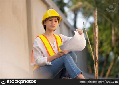 Woman Supervisor hard hat safety suit holding blueprint inspection building estate construction,Working woman