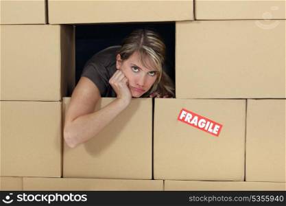 woman surrounded by cartons