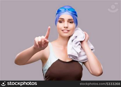 Woman swimmer against grey background