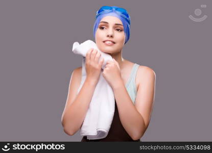 Woman swimmer against grey background