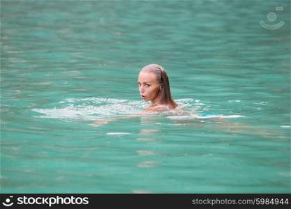 Woman swimming in sea. Woman swimming and relaxing in blue water of sea in Thailand