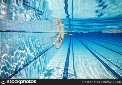 woman swimming in the poolin the pool under water