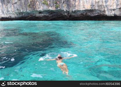 Woman swimming surrounded by fish, Andaman Sea, Thailand