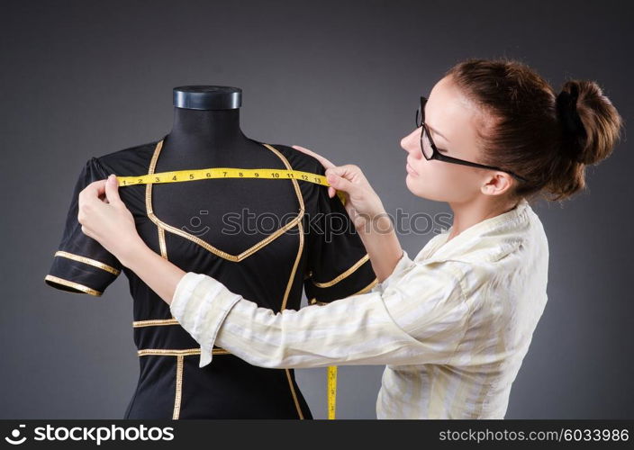 Woman tailor working on clothing