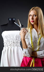 Woman tailor working on dress