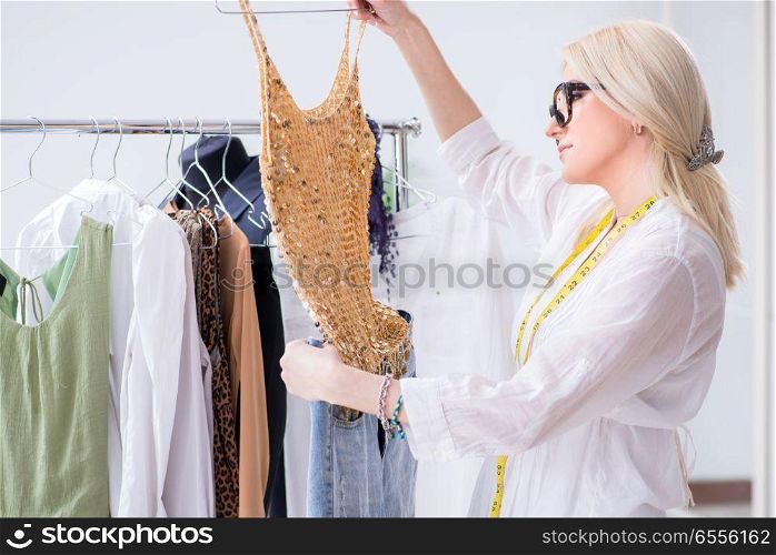 Woman tailor working on new dress designs