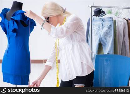 Woman tailor working on new dress designs