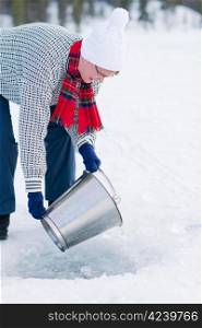 Woman take a loose ice out from a ice hole.