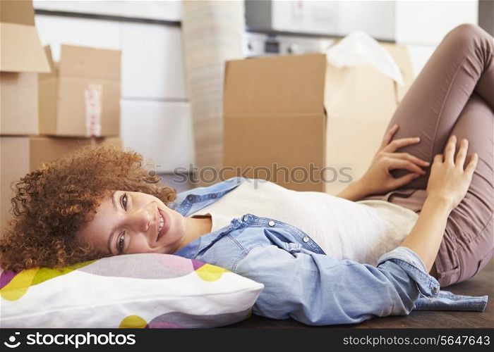 Woman Taking A Break Whilst Moving Into New Home