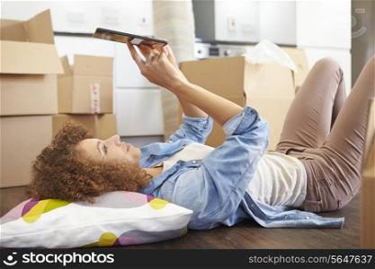 Woman Taking A Break With Digital Tablet In New Home