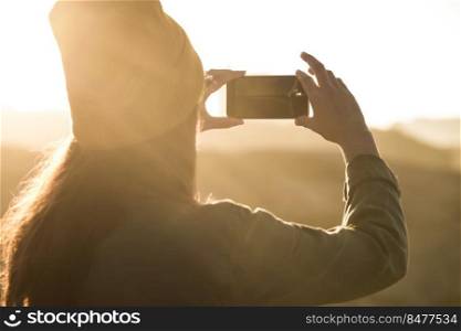 Woman taking a picture with her cellphone