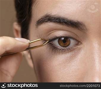 woman taking care her eyelashes