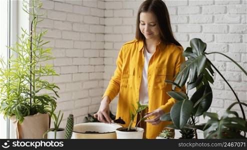 woman taking care her plants her home garden 3