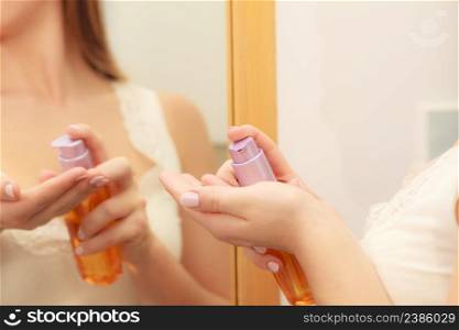 Woman taking care of her dry skin applying moisturizer cream oil lotion on her body in bathroom. Beauty treatment. Skincare spa treatment.. Woman applying body oil lotion cream on her body