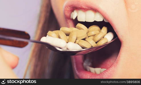 Woman taking eating pills tablets. Drug addict.. Woman taking pills. Girl female eating stack of tablets. Drug addict and health care concept. Overdose. Instagram filtered.