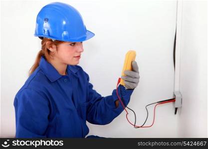 Woman taking electrical reading