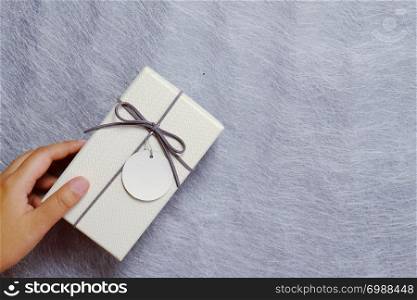 Woman taking gift box out of parcel