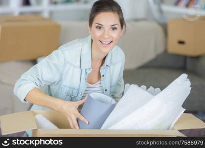 woman taking lamp out of box