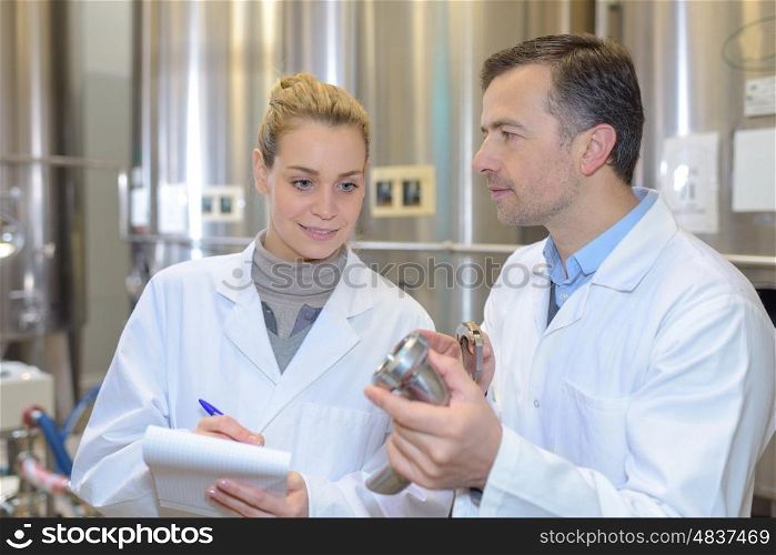 woman taking notes at a factory