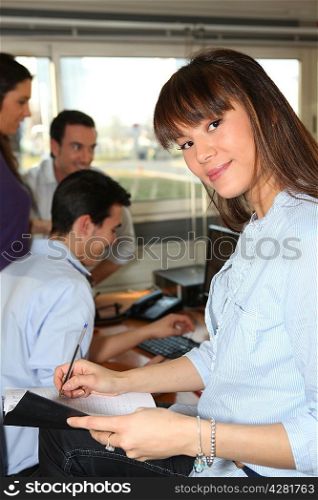Woman taking notes in a friendly office