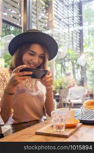 Woman taking photo on food in cafe,Life style concept