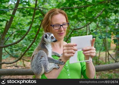 woman taking photo selfie with ring tailed lemur. woman taking photo selfie with ring tailed lemur animal outdoor