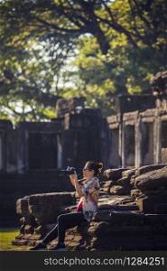 woman taking photograph by dslr camera in thailand traveling destination